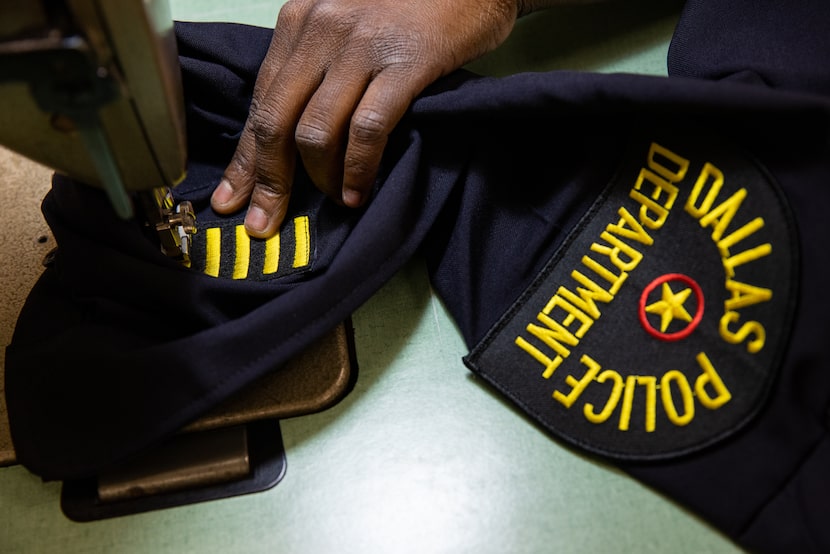 Tailor Autumn Bradley adds service stripes to Dallas Police Chief Eddie García's uniform at...