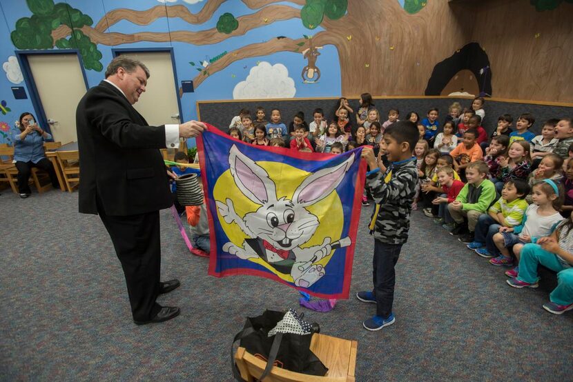 
Wylie Mayor Eric Hogue enlists the help of first-grader Pedro Resendiz for a magic trick at...