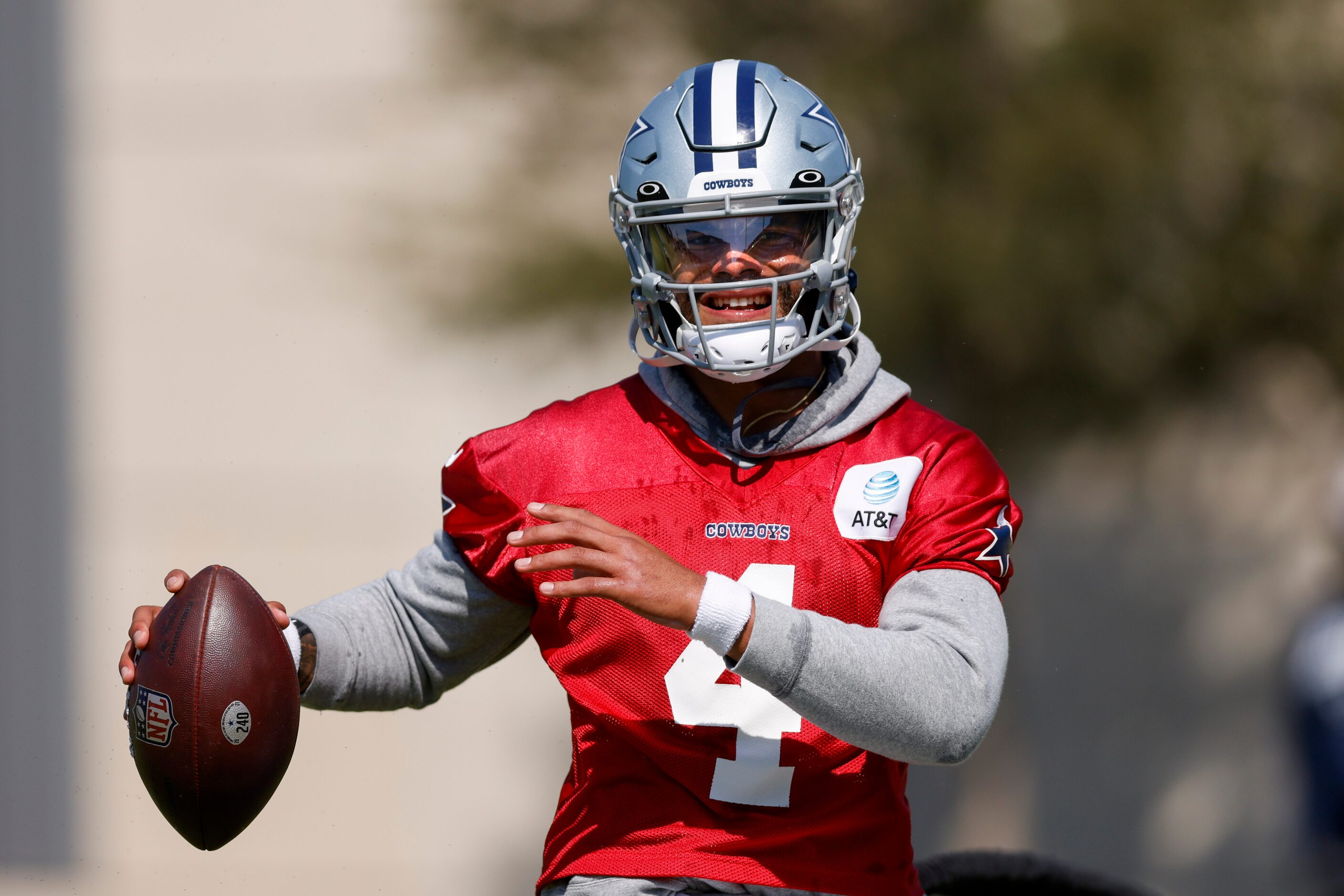 Dallas Cowboys quarterback Dak Prescott (4) trains while holding a football with his injured...