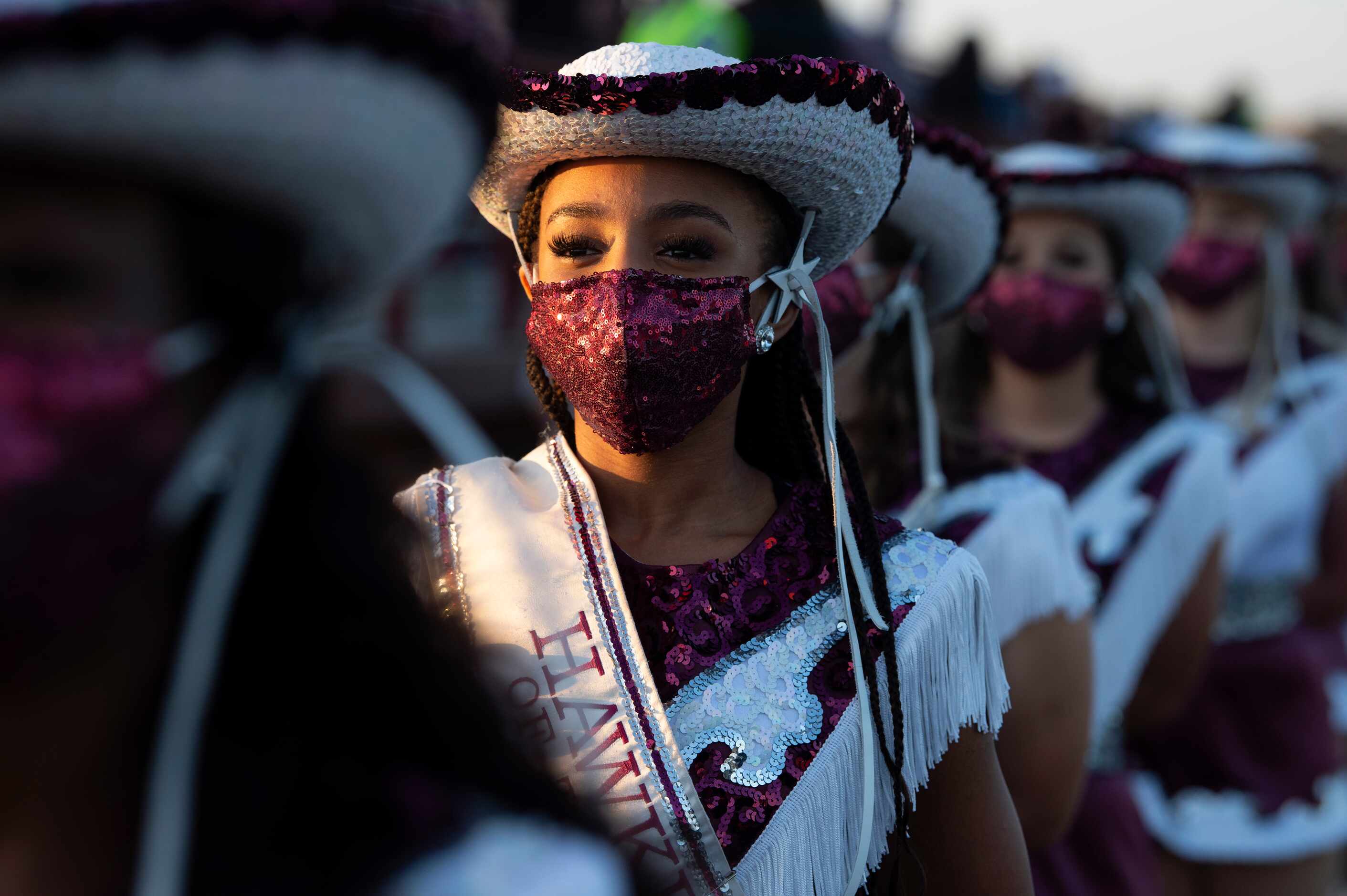 Red Oak sophomore Hawkette Micah Johnson wears a sequined mask before a high school football...