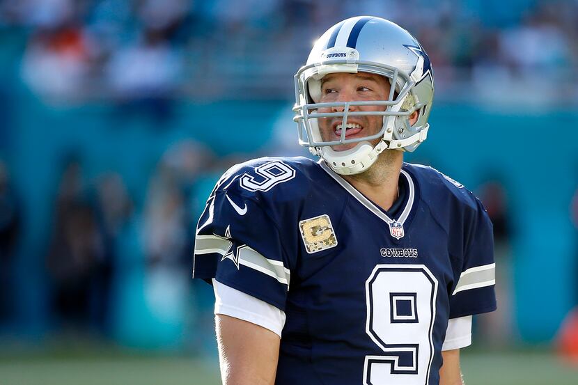 Dallas Cowboys quarterback Tony Romo smiles in the last seconds of the Miami Dolphins game...