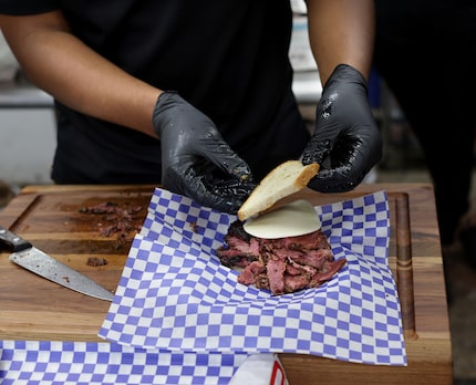 Brent Reaves, co-owner of Smokey John's Bar-B-Que, makes the famed pastrami sandwich on Oct....