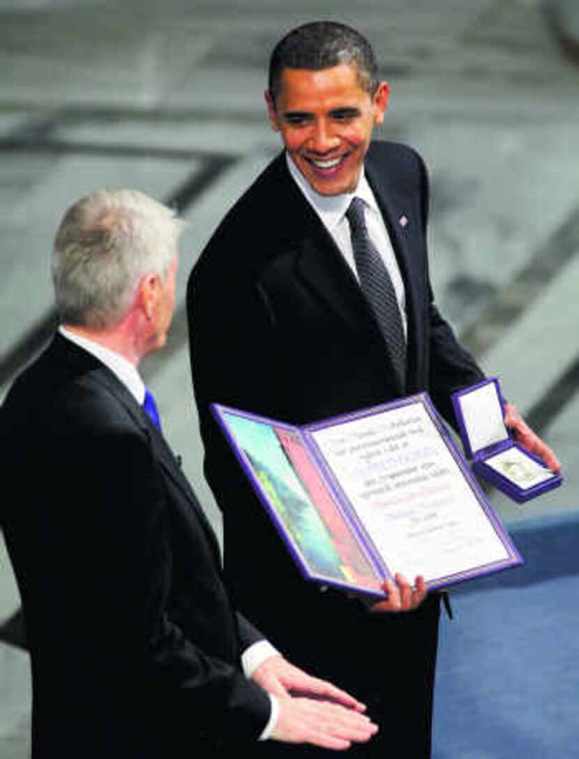 President Barack Obama accepted his Nobel gold medal and diploma from Thorbjorn Jagland,...