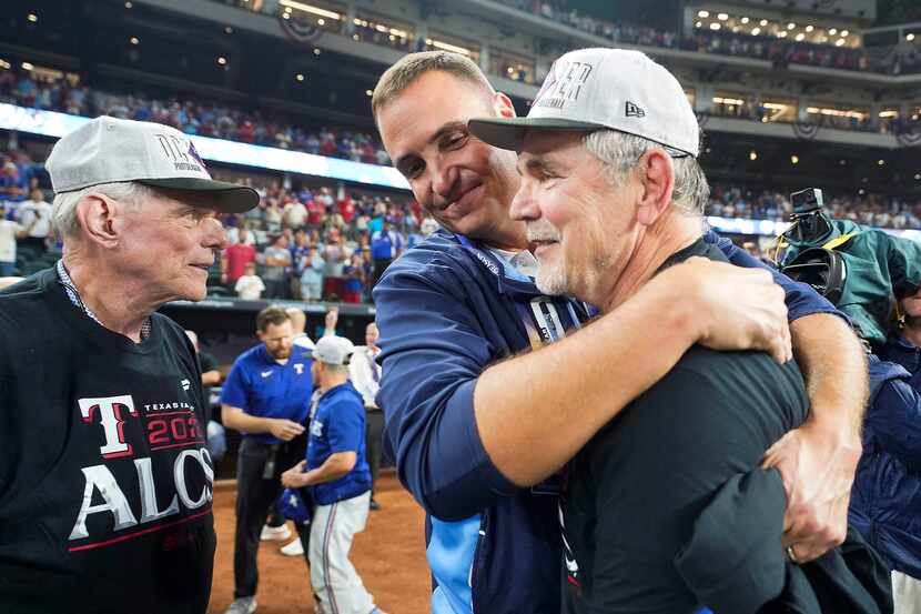 Texas Rangers general manager Chris Young hugs manager Bruce Bochy as chairman & managing...