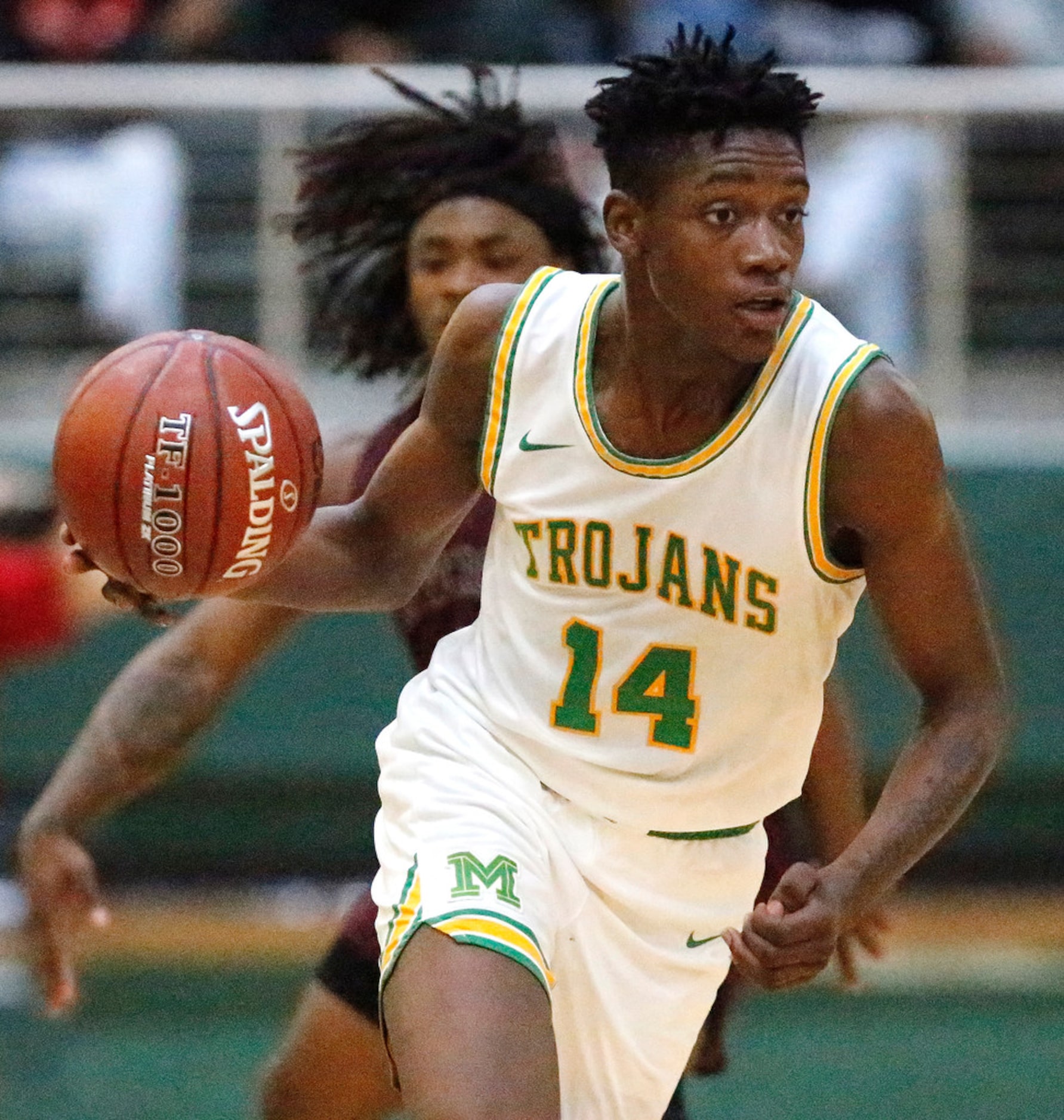 Madison High School forward Leonard Miles (14) brings the ball down the floor during the...