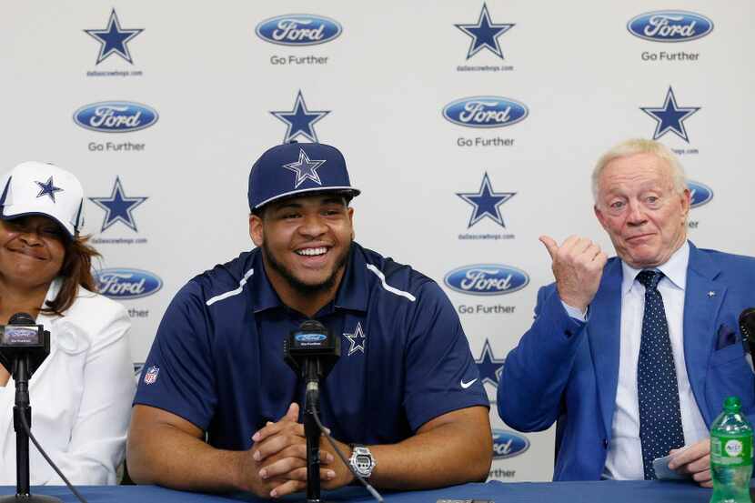 Dallas Cowboys owner Jerry Jones points to former LSU offensive lineman La'el Collins, with...
