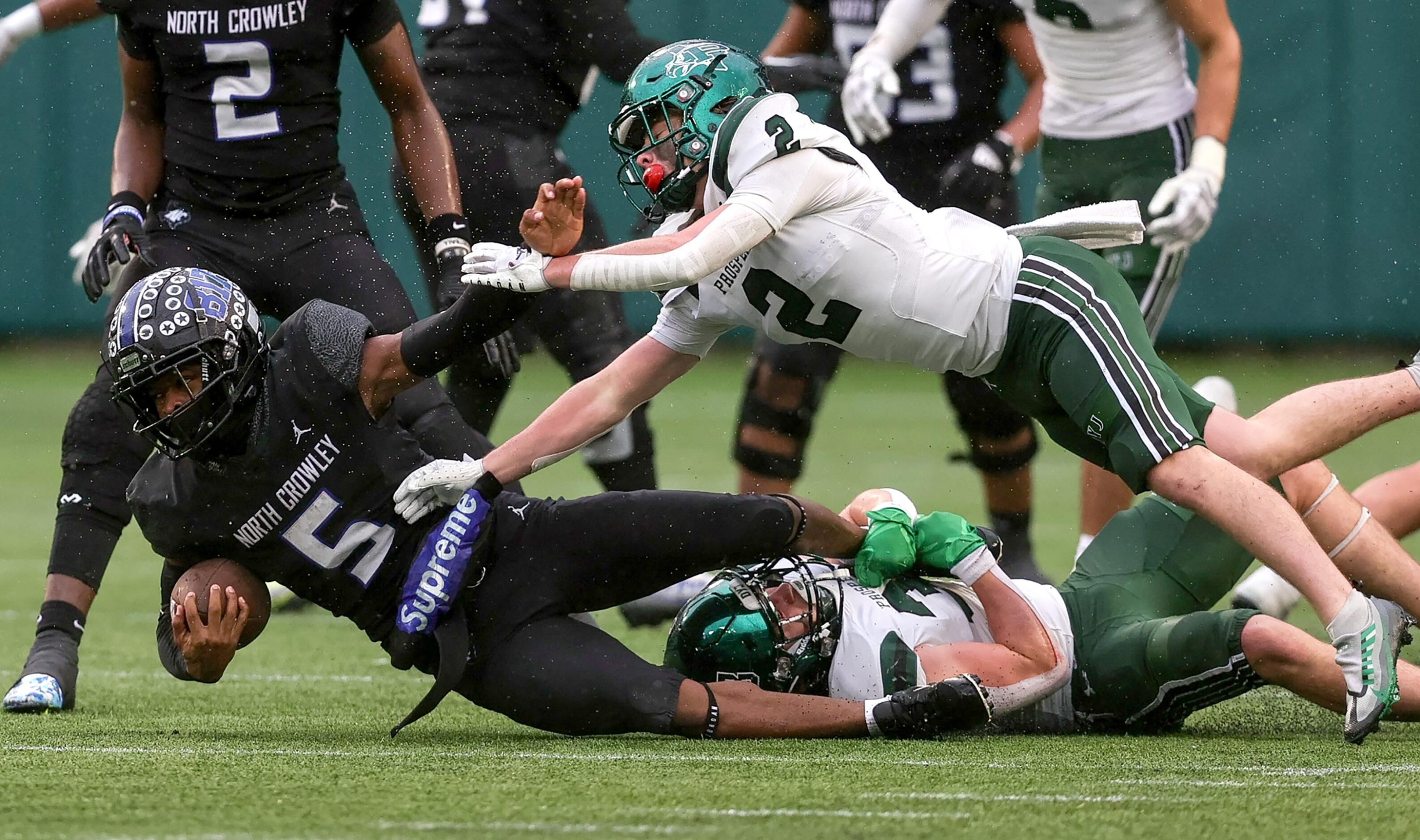 North Crowley running back Dejuan Lacy (5) is dragged down by Prosper linebacker Jonah...