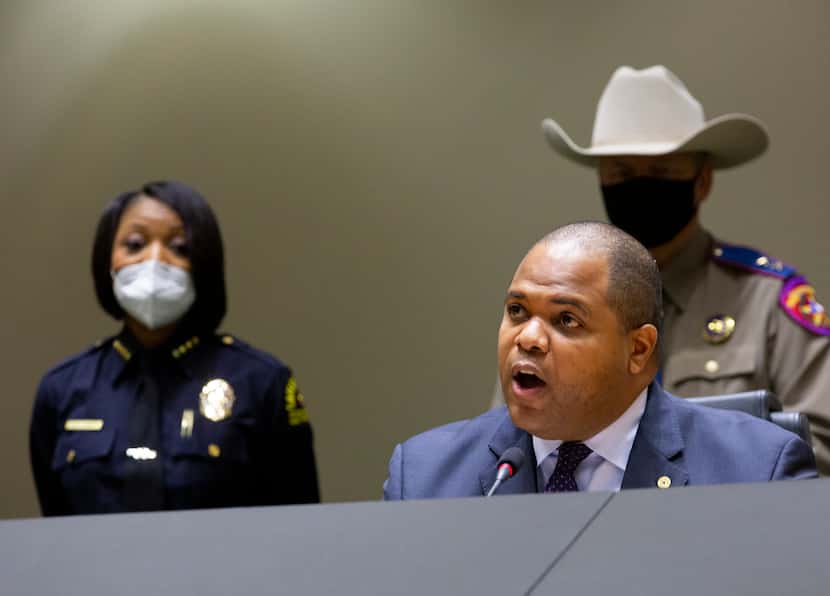 Dallas Police Chief Reneé Hall (left) listens as Dallas Mayor Eric Johnson speaks at a news...