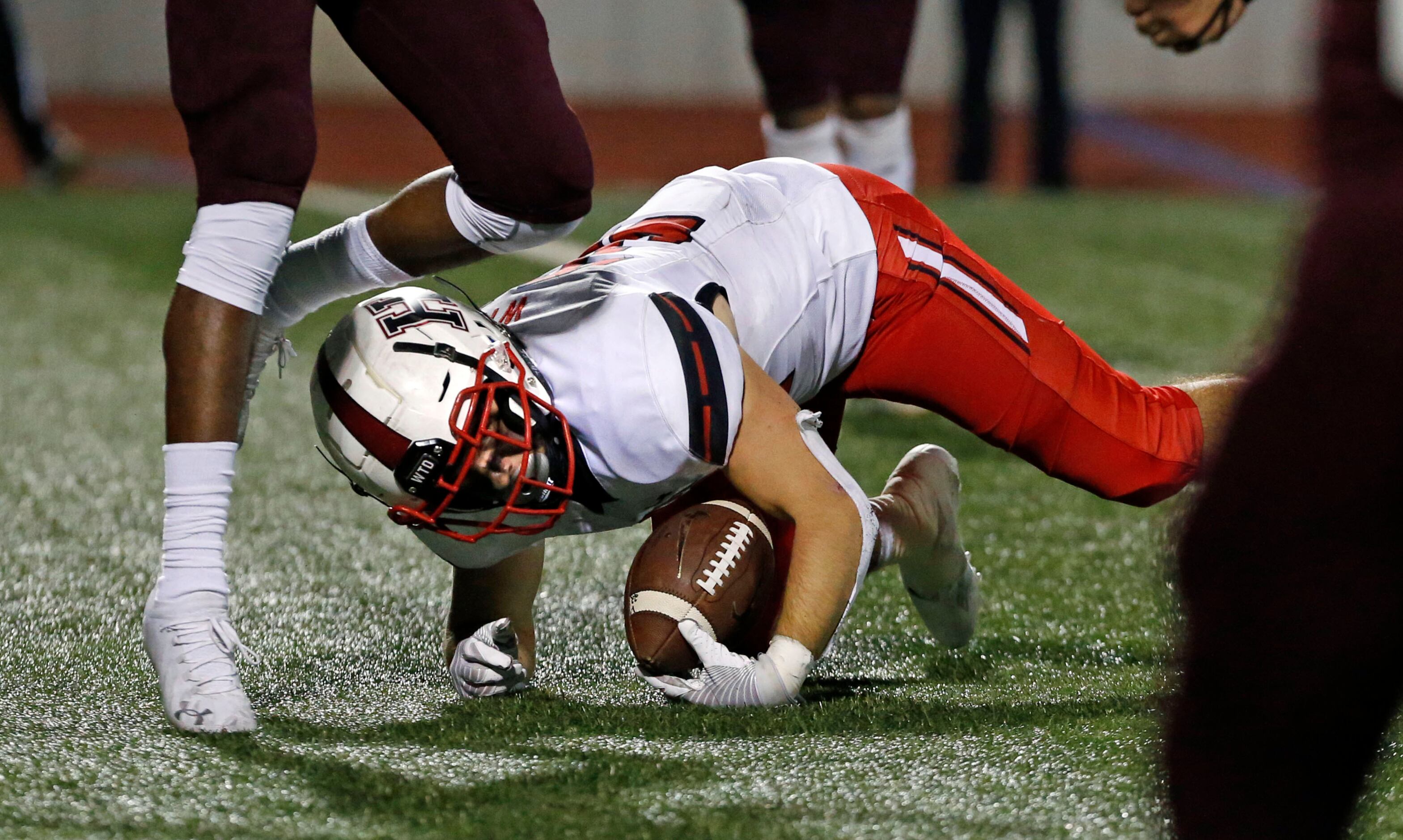 Rockwall Heath RB Brittan Snider (32) tumbles into the end zone for a touchdown during the...