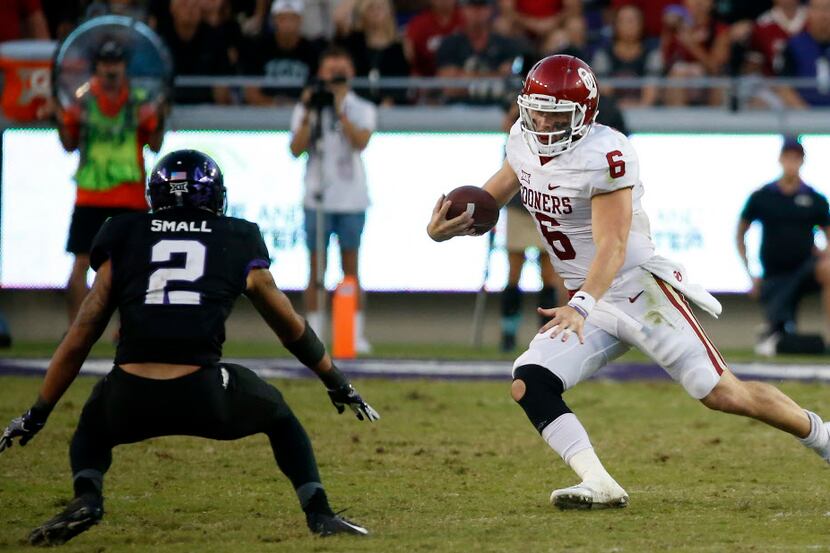 Oklahoma quarterback Baker Mayfield (6) looks for running room as TCU safety Niko Small (2)...