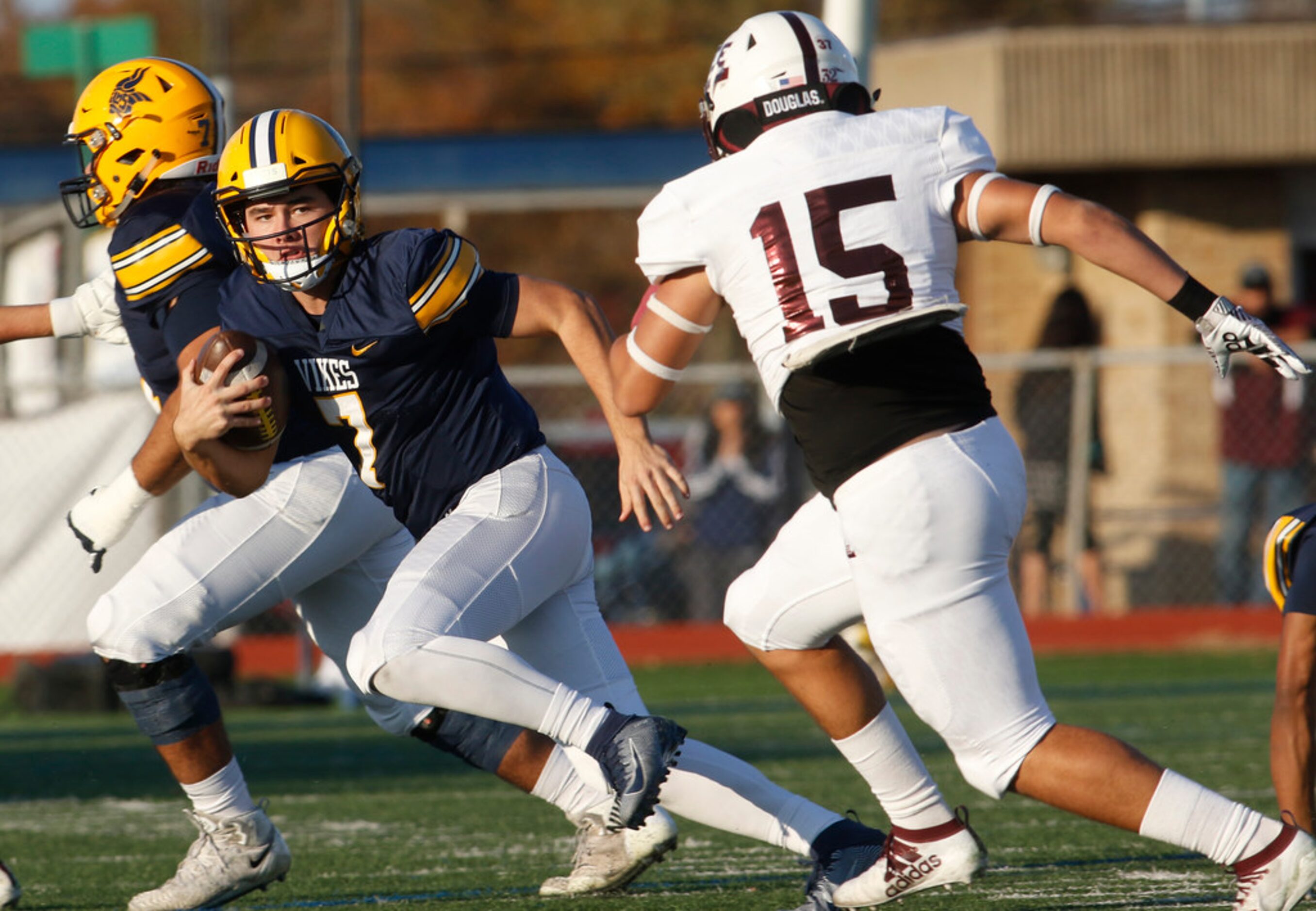 Arlington Lamar quarterback Jack Dawson (7) rolls out of the pocket on a quarterback keeper...