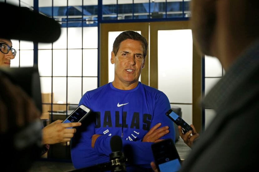 Dallas Mavericks owner Mark Cuban (center) talks with the  media in an interview during the...