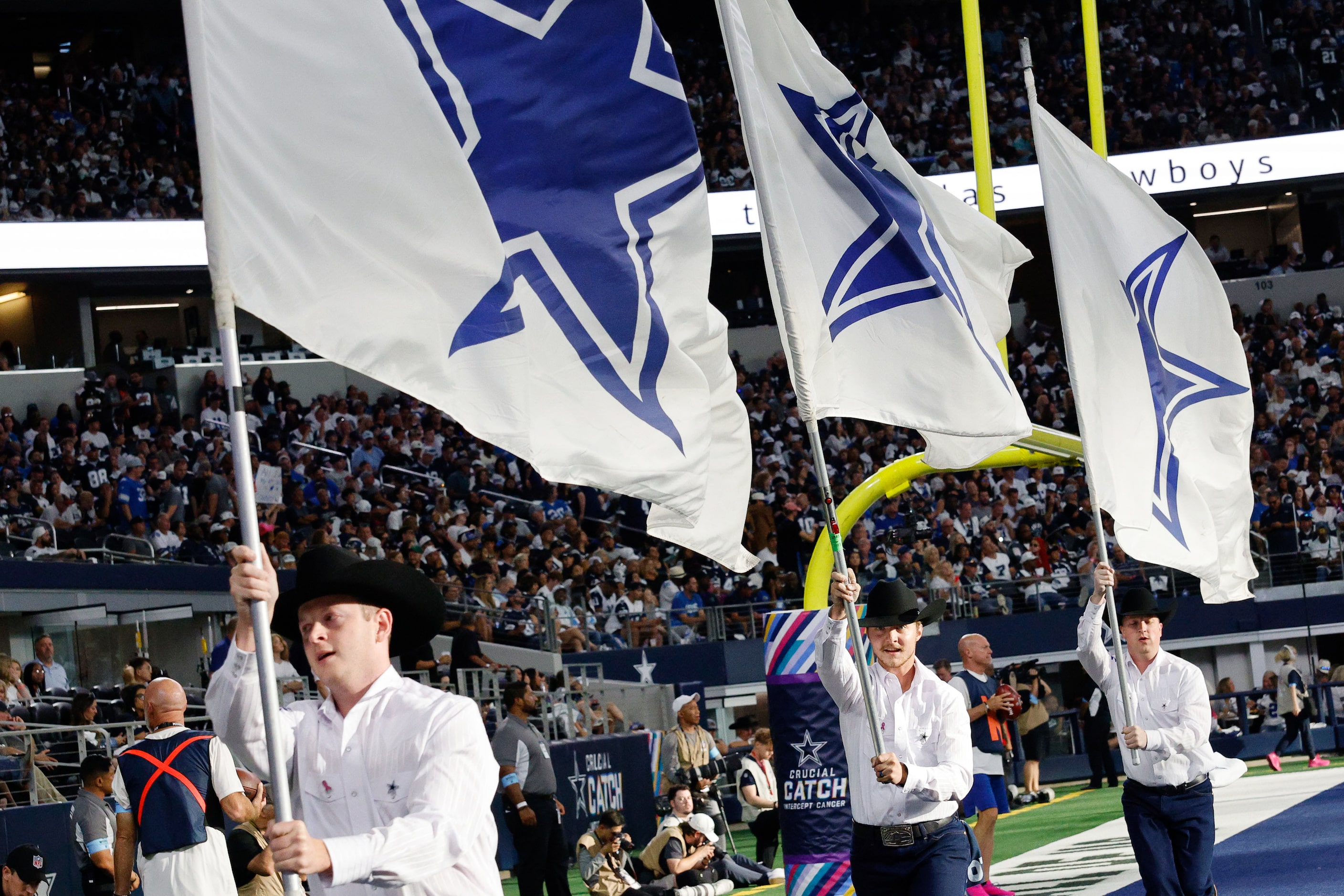 Dallas Cowboys flag team members run in the second half of an NFL football game against the...