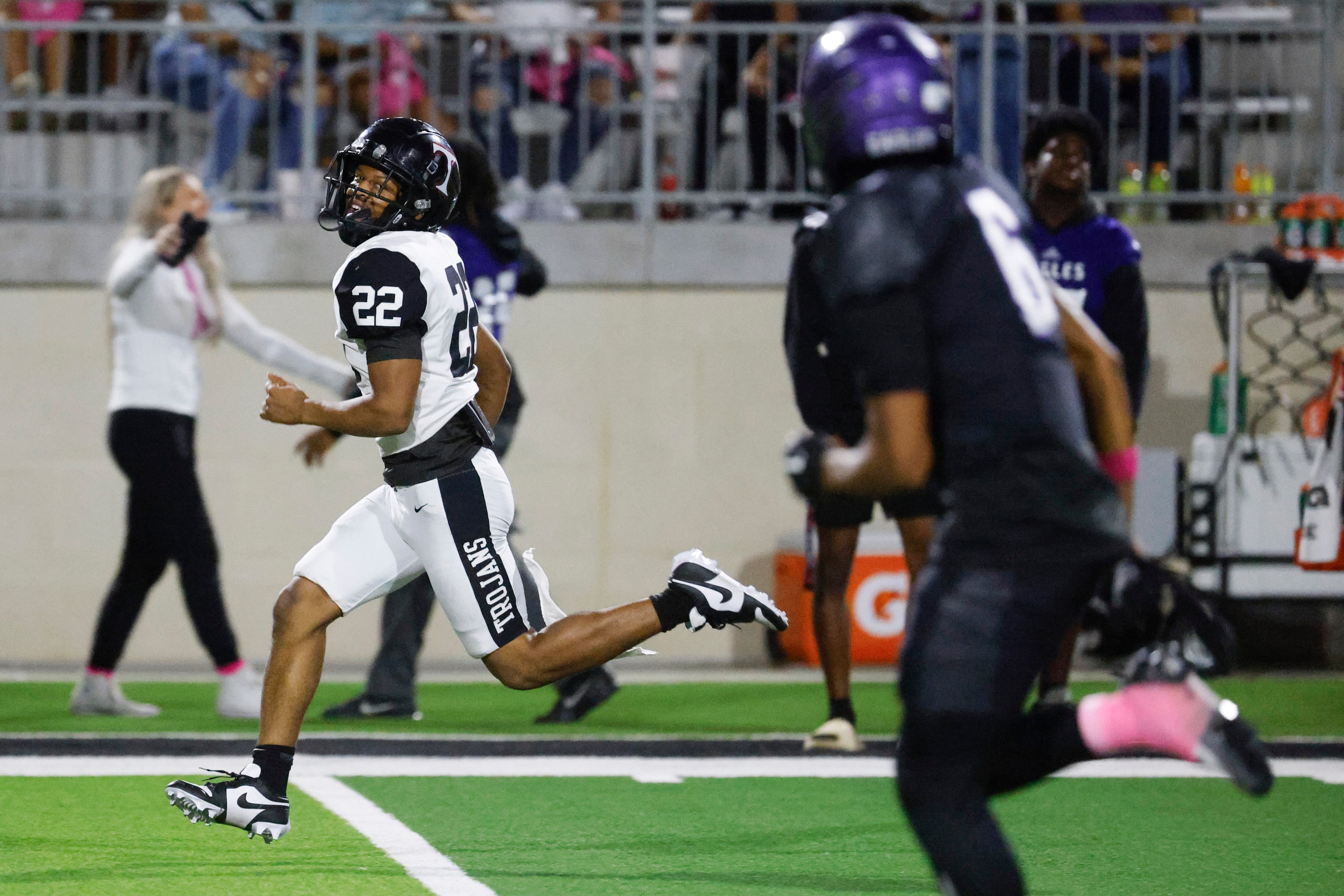 Trinity High’s JT Harris (22) looks back as he completes a run for a touchdown against...