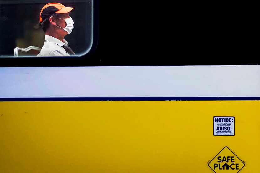 A rider wearing a face mask rode a train at the DART rail St. Paul Station in downtown...