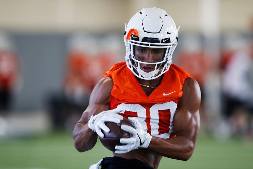 In this Thursday, Aug. 1, 2019 photo, Oklahoma State running back Chuba Hubbard catches a...