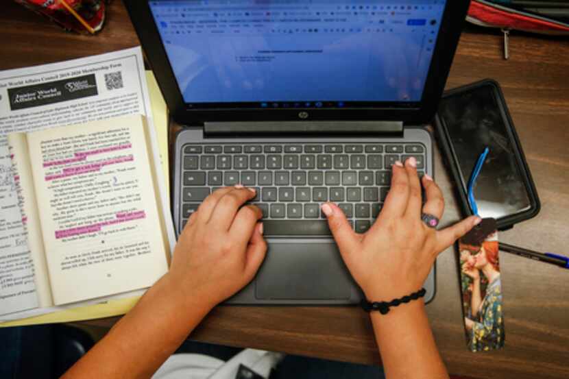 Priscilla Beltran, 17, of Dallas, does homework using a laptop during lunch period at Lake...