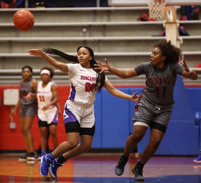 Duncanville's Hope LeMelle (00) defends as a pass makes its way towards Cedar Hill's Portia...