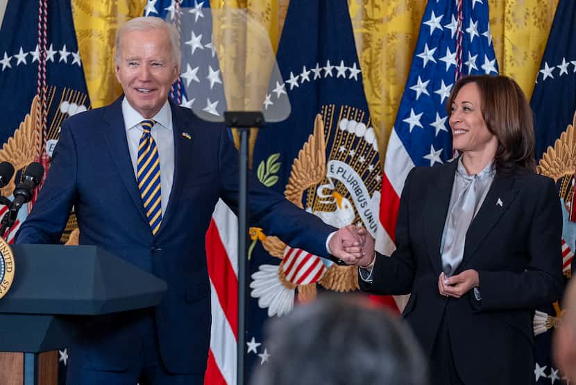 El presidente Joe Biden, da la mano a la vicepresidenta Kamala Harris mientras habla en una...