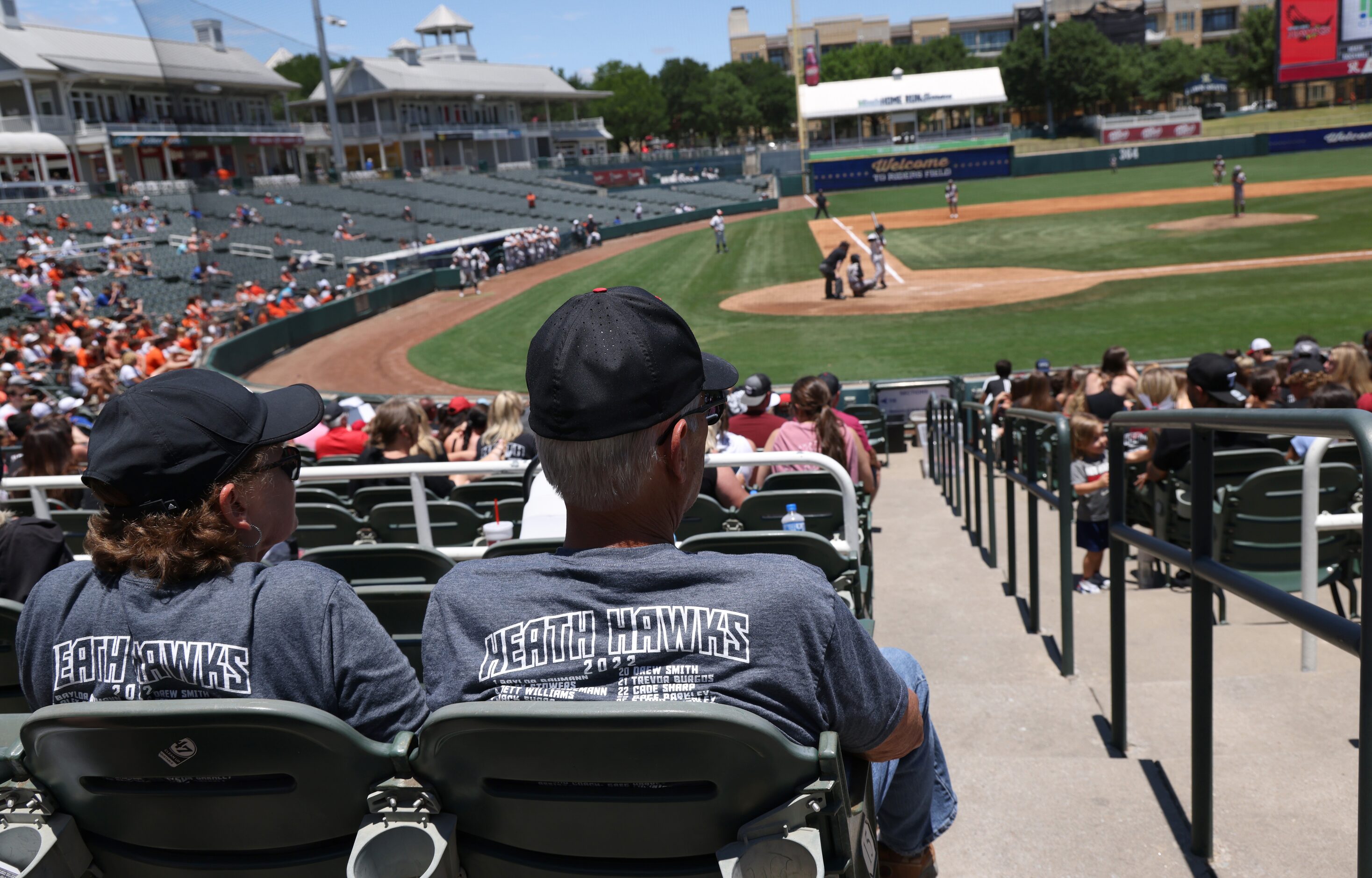 A pair of Rockwall Heath fans follow the action during the 5th inning of Heath's 6-0 victory...