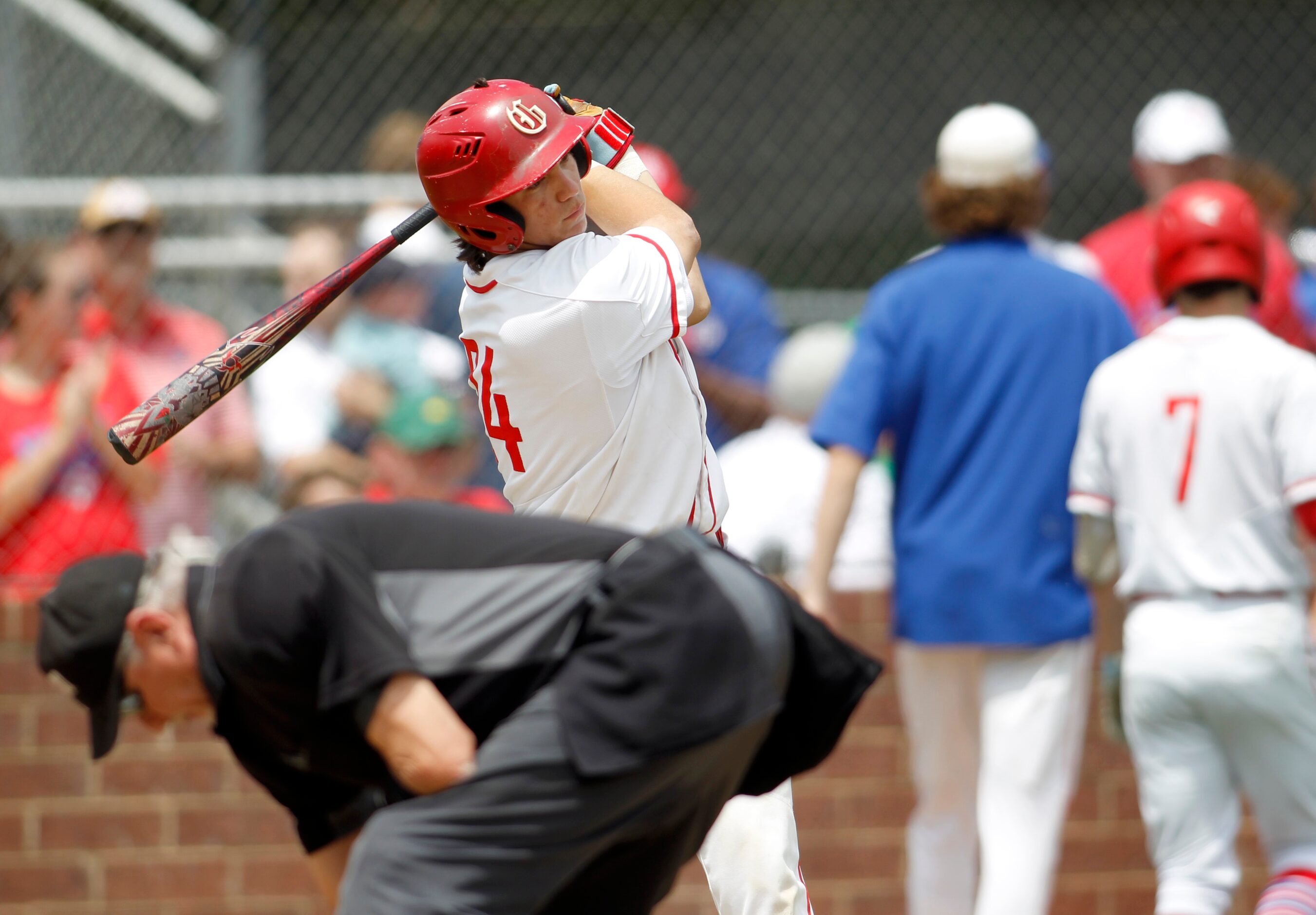 Grapevine's Seve Aguirre (24) takes a practice swing as an umpire cleans home plate during...