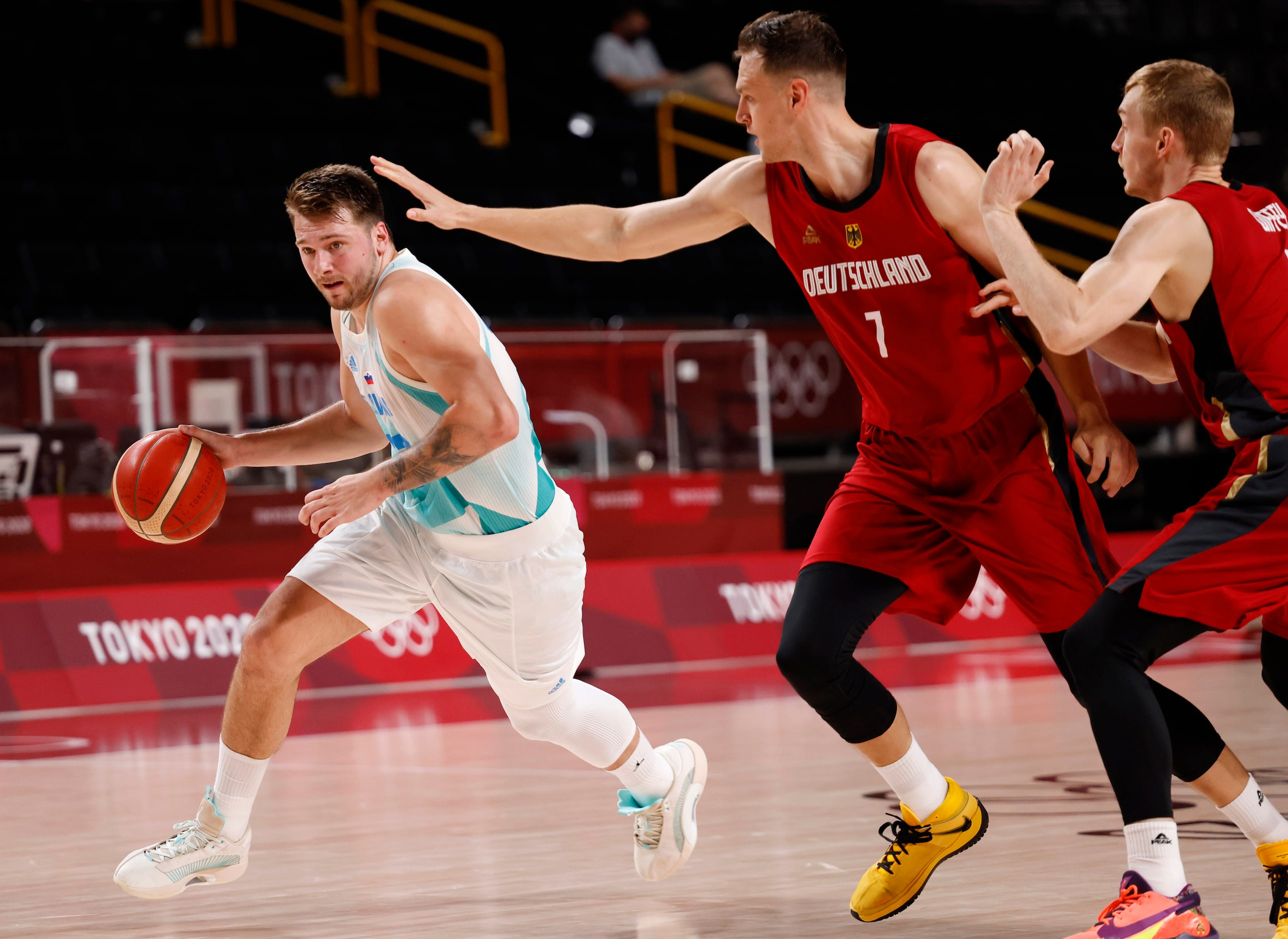 Slovenia’s Luka Doncic (77) drives on Germany’s Johannes Voigtmann (7) during the first half...