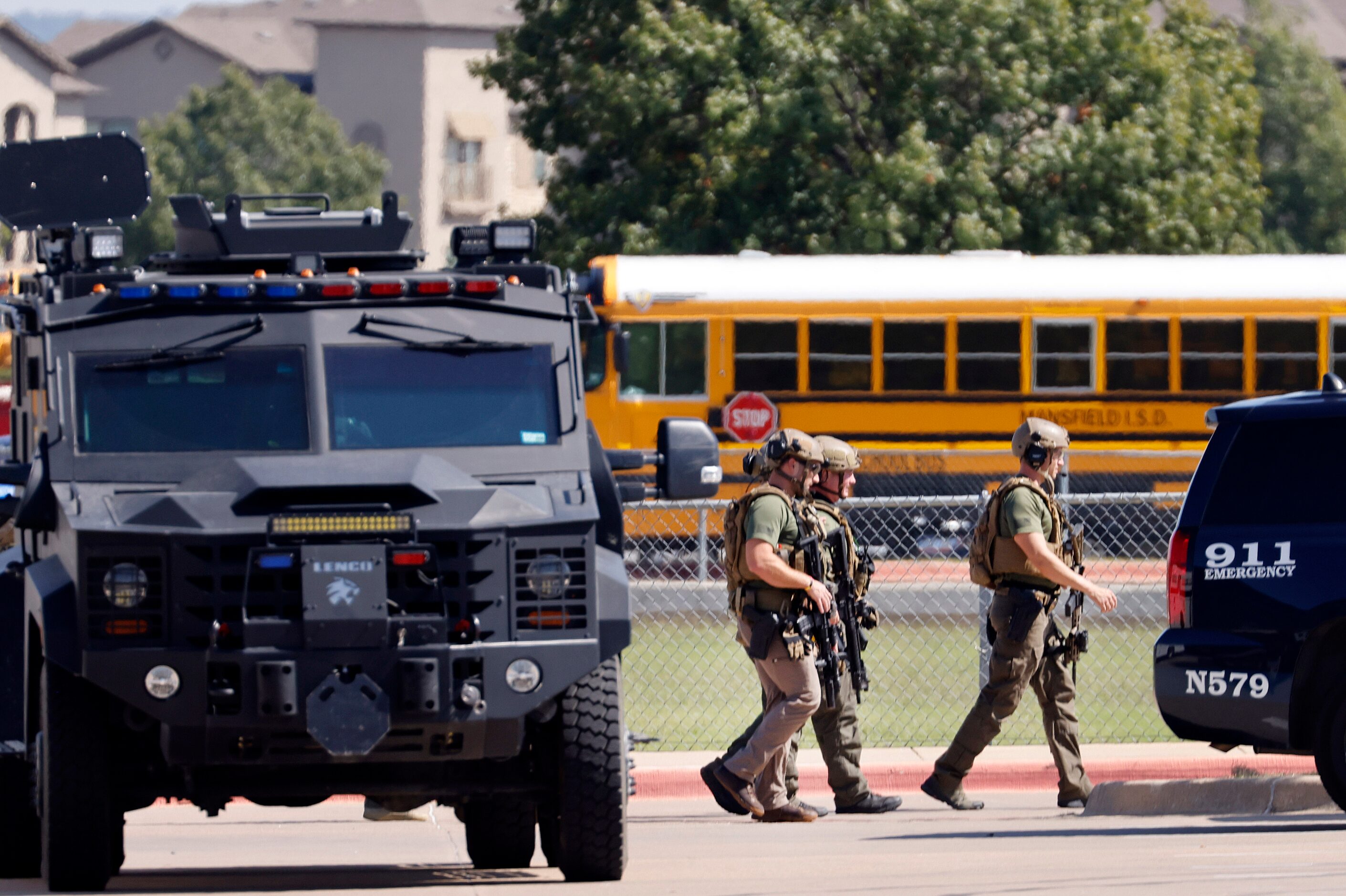 Tactical officers clear the scene following a shooting inside Mansfield Timberview High...