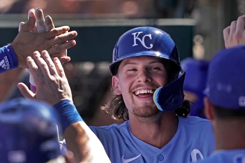 Kansas City Royals' Bobby Witt Jr. celebrates in the dugout after scoring on a sacrifice fly...