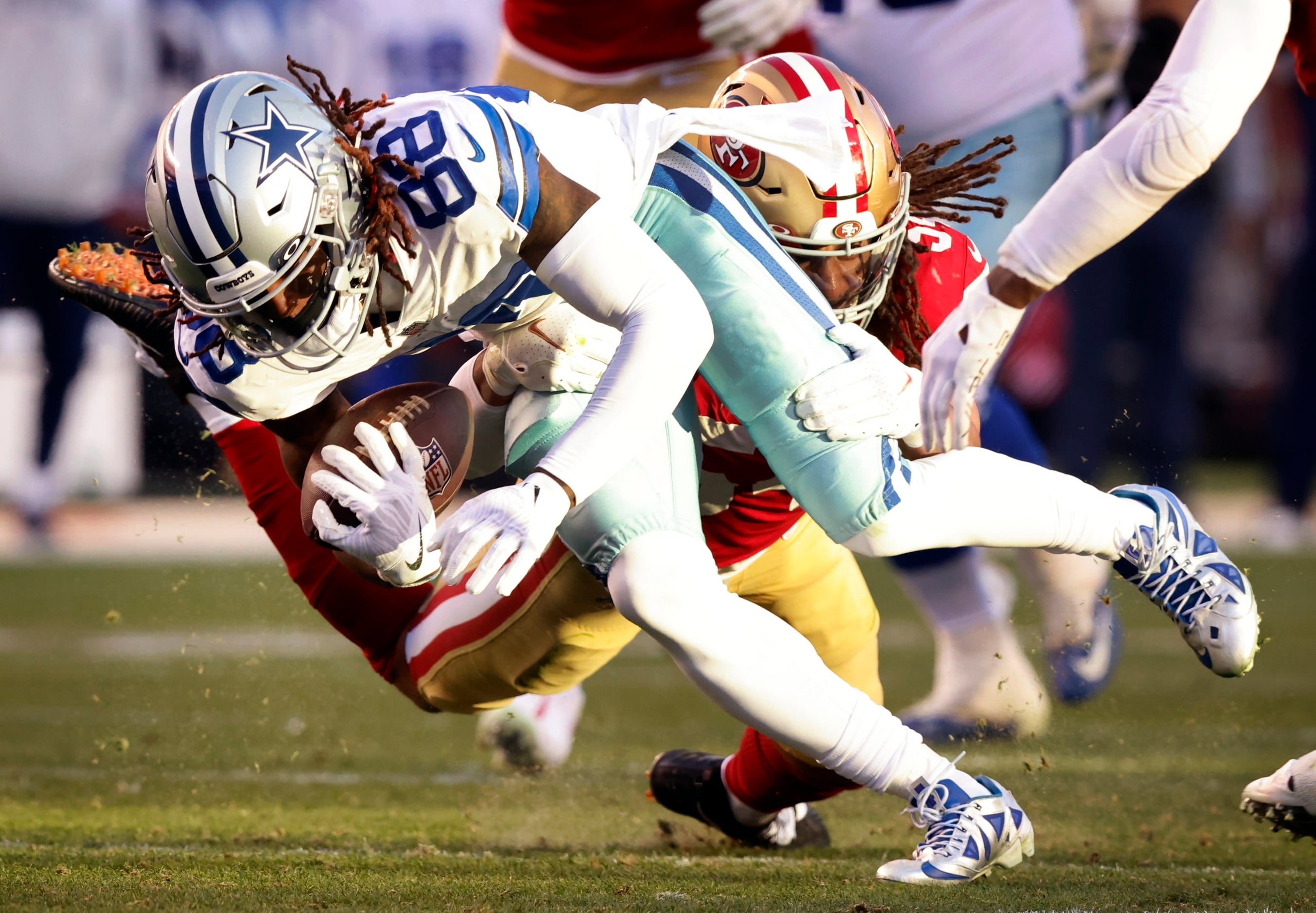 San Francisco 49ers linebacker Fred Warner (54) and Dallas Cowboys wide  receiver CeeDee Lamb (88) after a stop during an NFL divisional round  playoff football game, Sunday, Jan. 22, 2023, in Santa