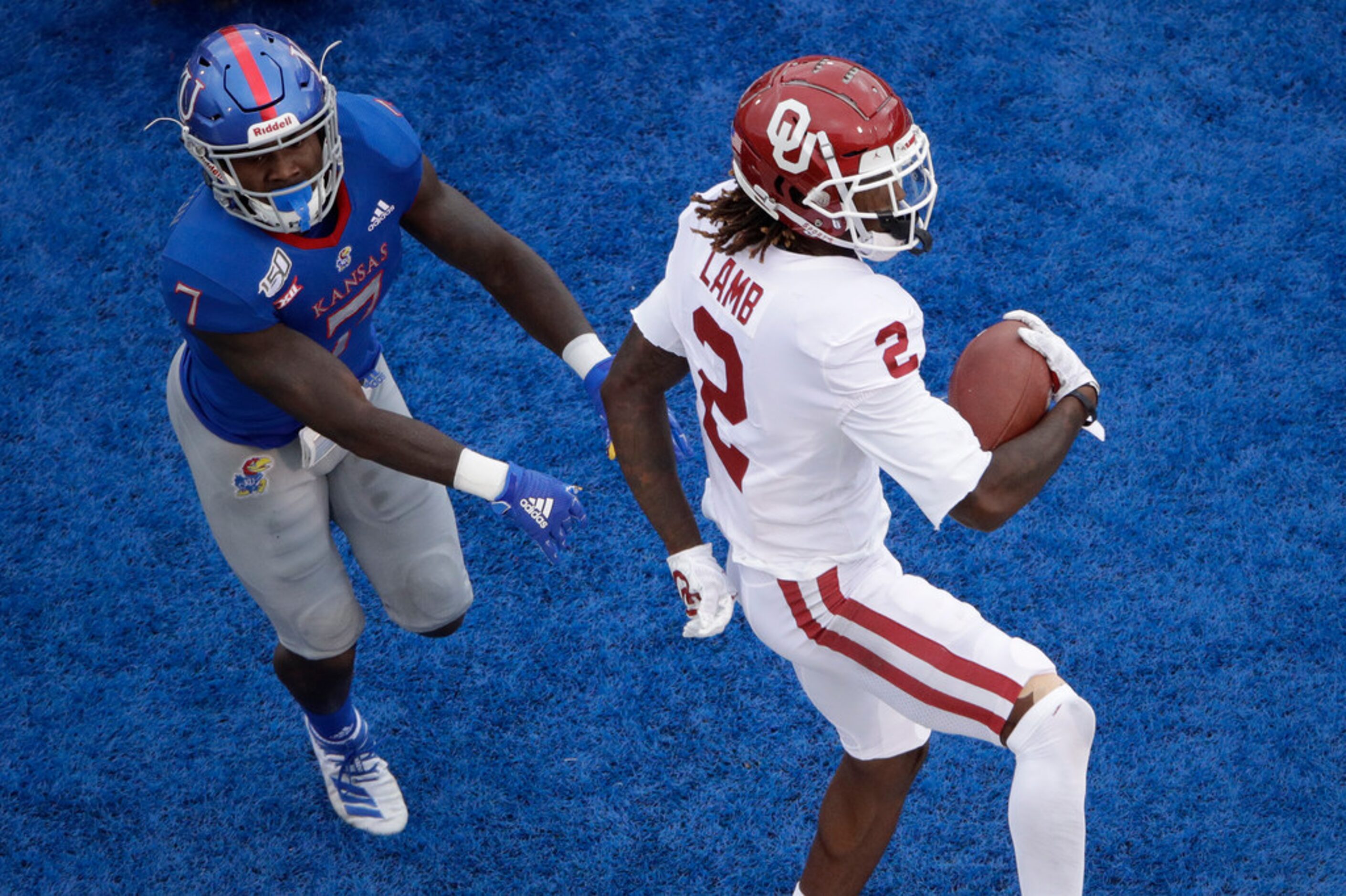 Oklahoma wide receiver CeeDee Lamb (2) beats Kansas safety Davon Ferguson (7) into the end...