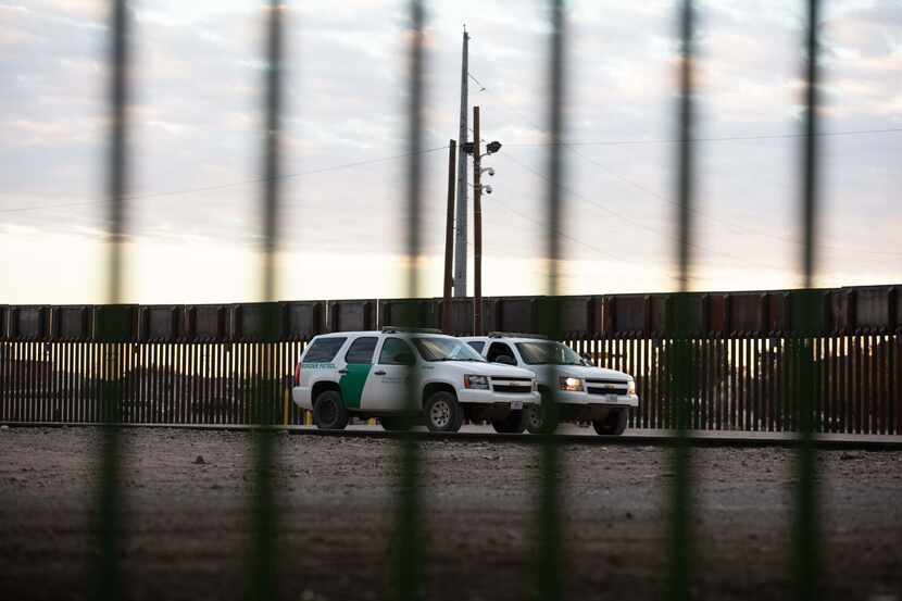 Border Patrol agents drive near the border wall in South El Paso on November 12, 2020.