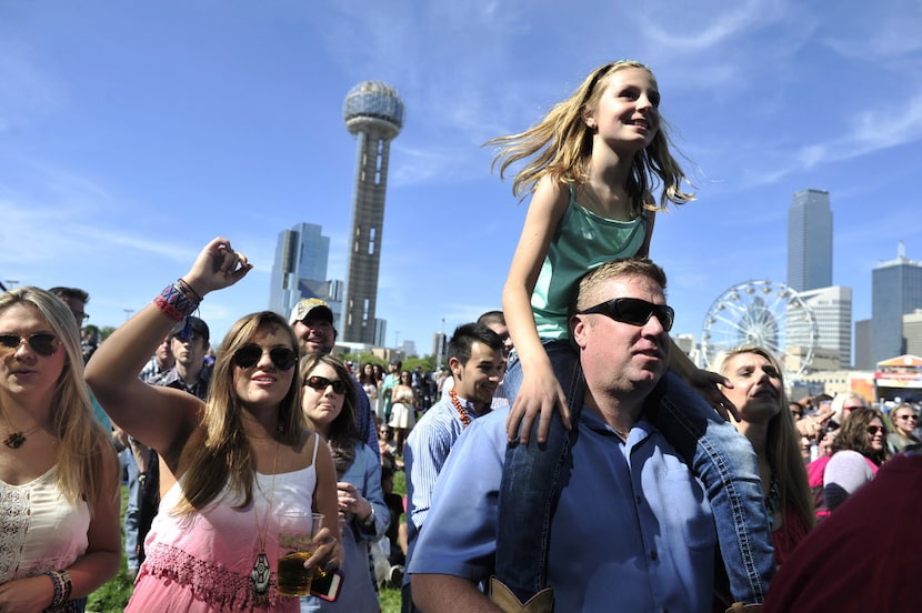 Julia Cavin sits atop her father Jay Cavin while listening to Jack Ingram perform onstage at...