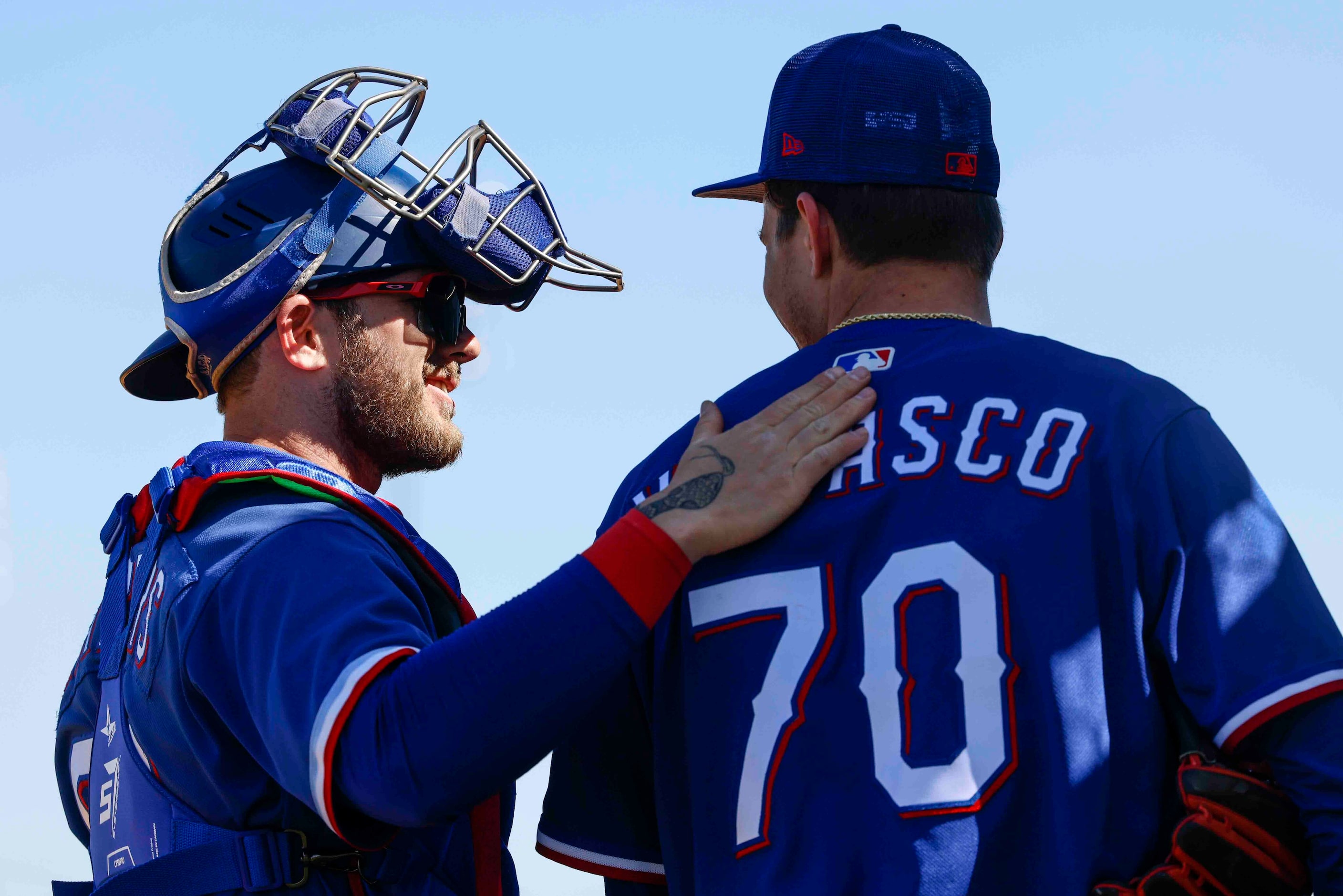 Texas Rangers minor league catcher Scott Kapers, left, pats Texas Rangers right handed...