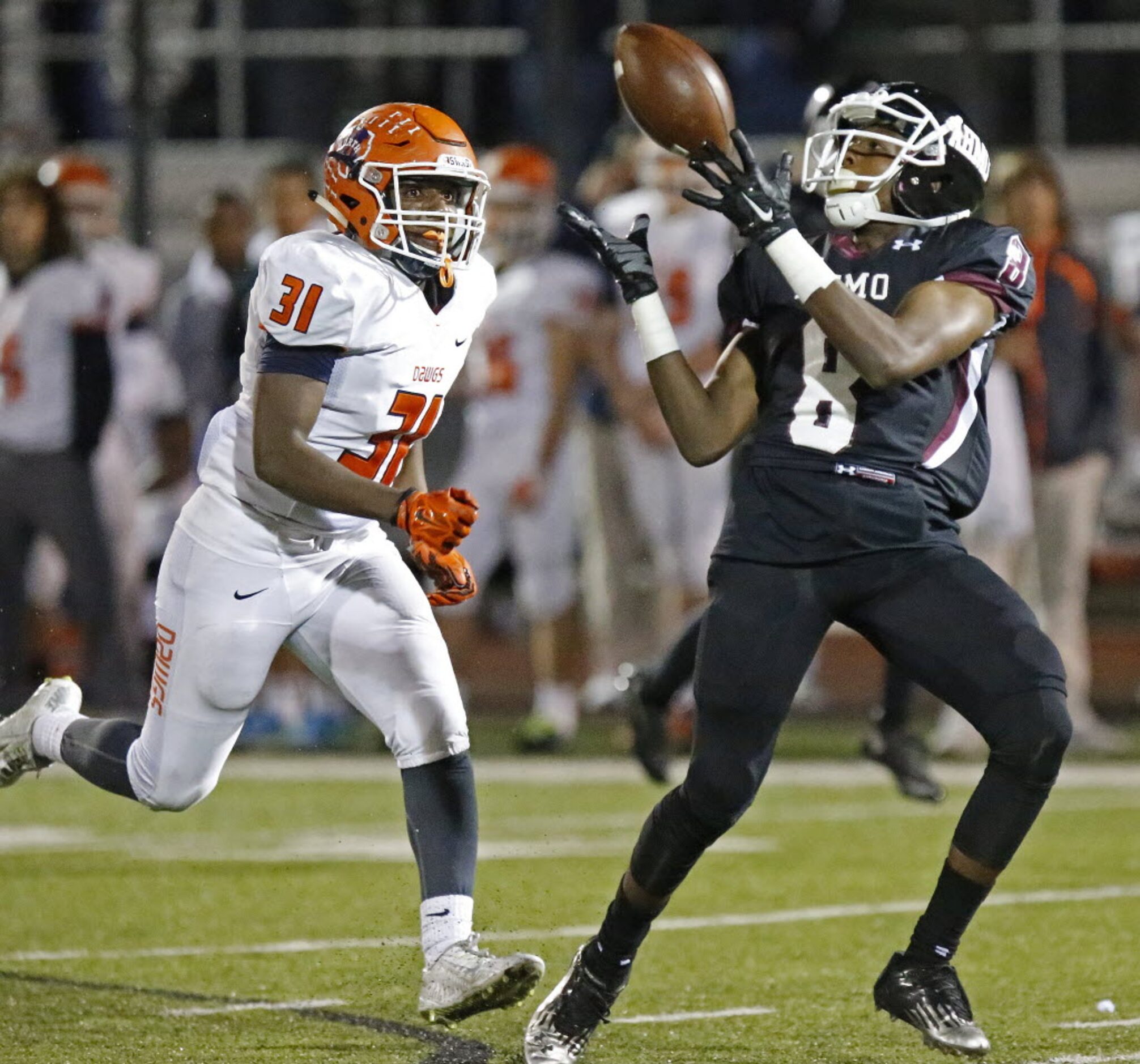 Wylie High School wide receiver Dru Thomas (8) hauls in a deep pass as he is covered by...