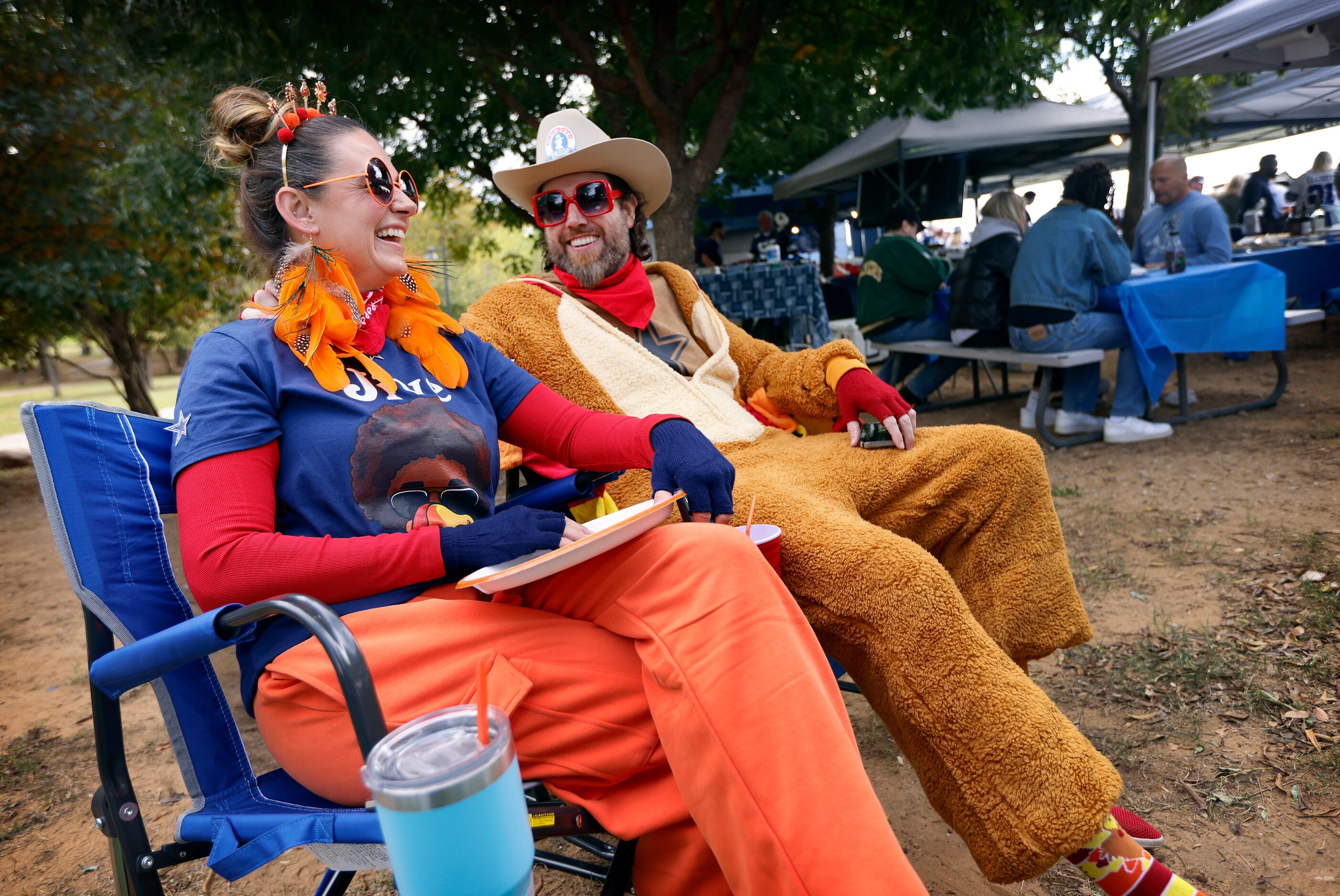 Dallas Cowboys fans Amber Brown of Dallas dressed as Jive Turkey Queen and her boyfriend...