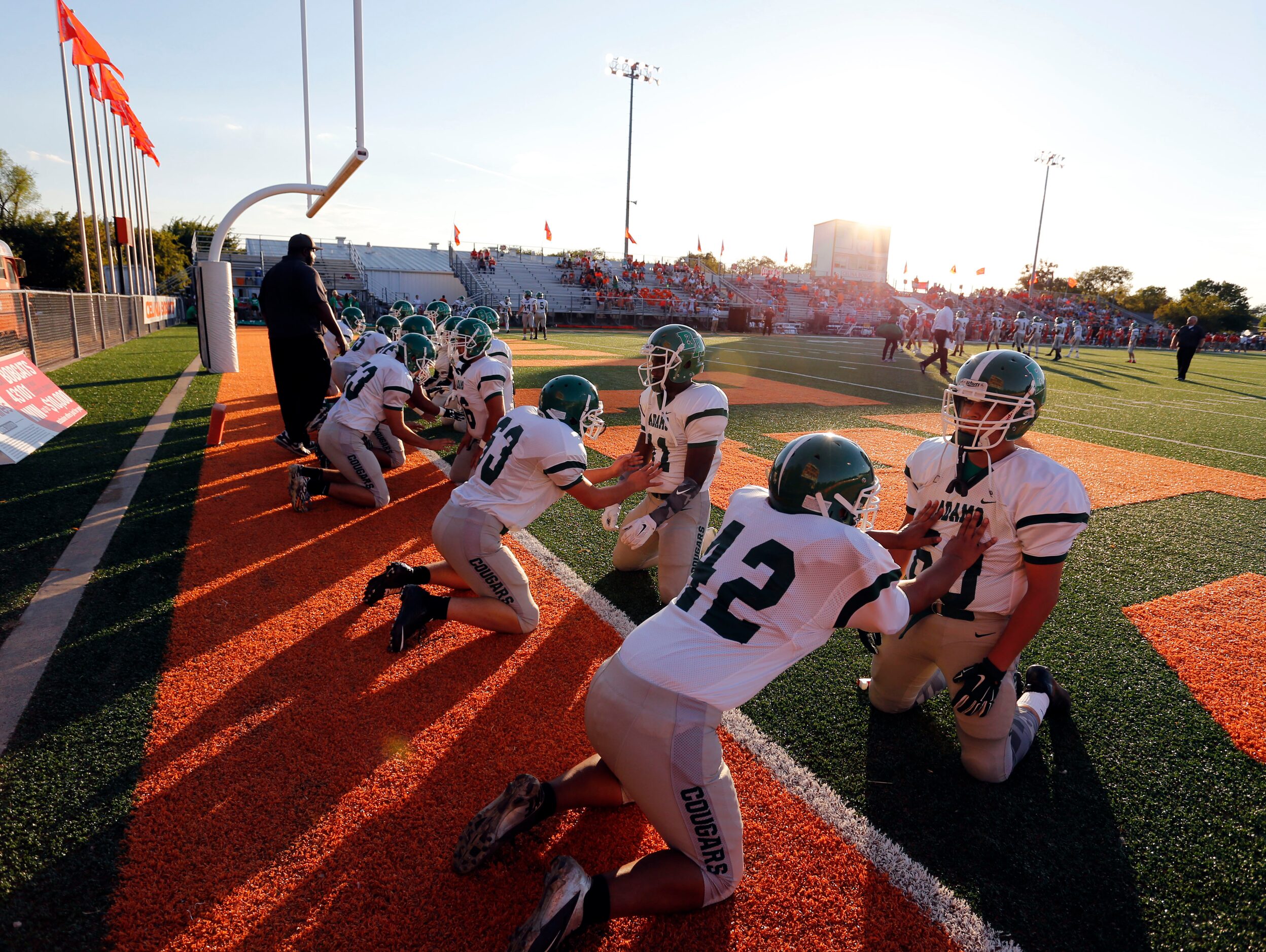 (TXHSFB) Bryan Adams team members, including  Orlando Sosa (42) and Henry Perez (60) perform...