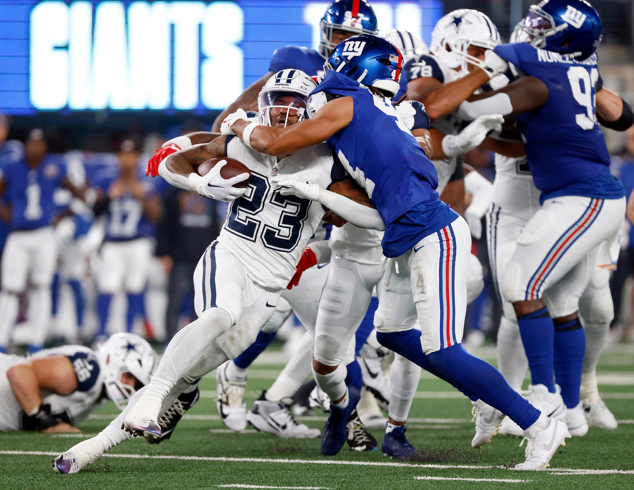 Dallas Cowboys running back Rico Dowdle (23) is trend back by New York Giants cornerback...