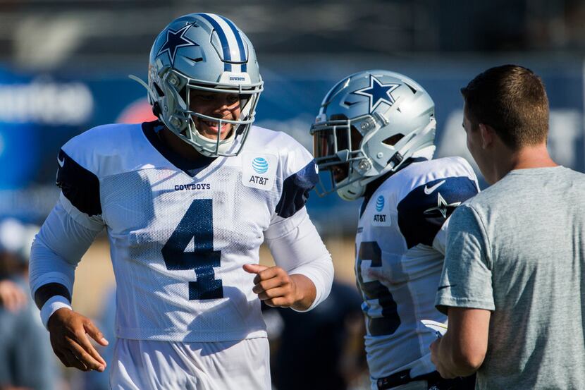 Dallas Cowboys quarterback Dak Prescott (4) makes his way to hear a play call from offensive...