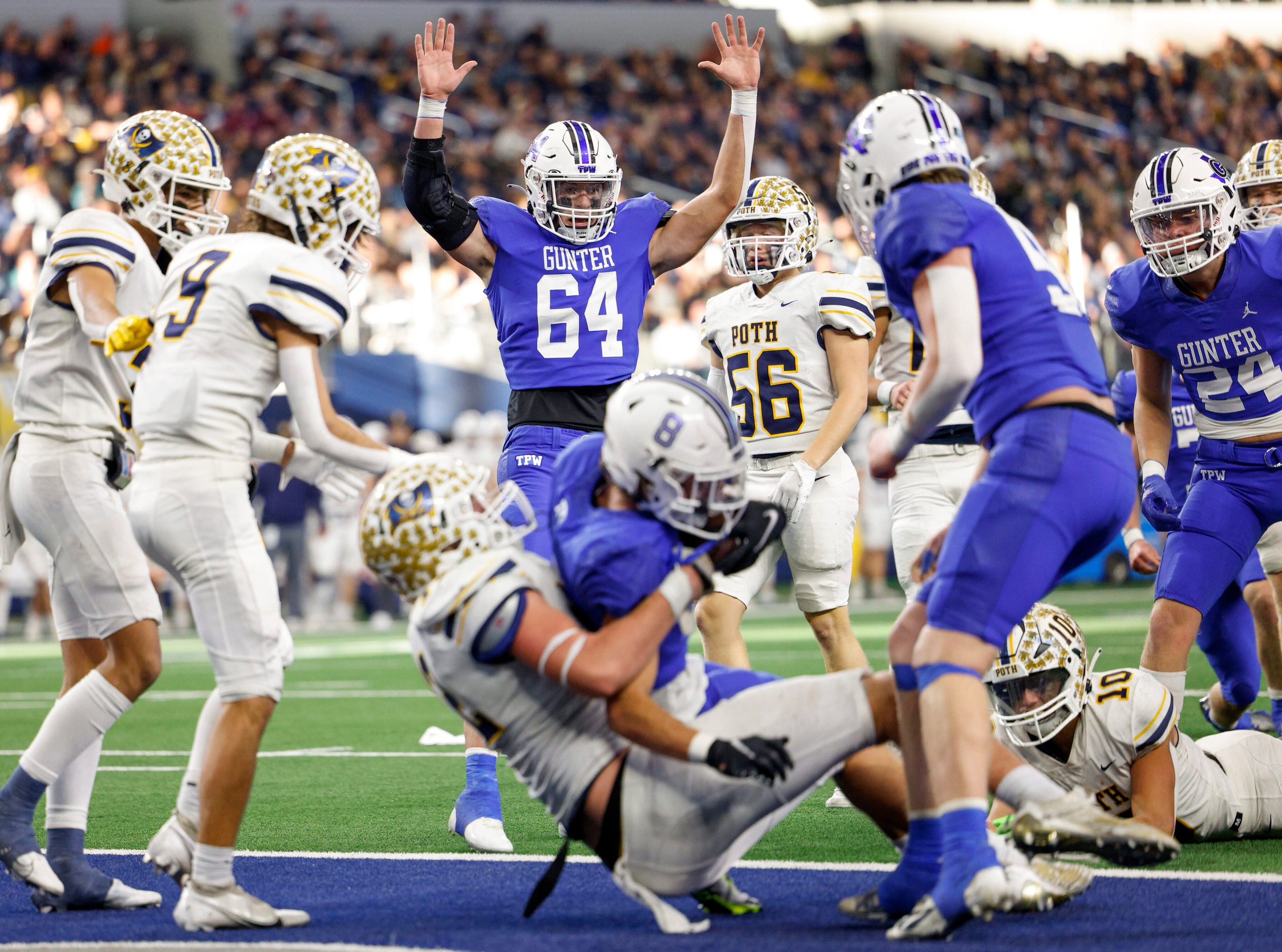 Gunter offensive lineman Jack St. Clair (64) celebrates as running back Ethan Sloan (8)...