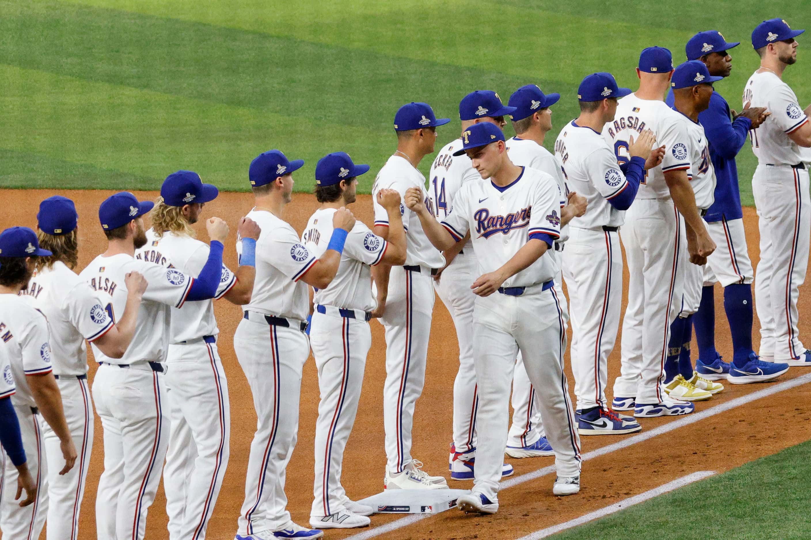 Texas Rangers shortstop Corey Seager (5) receives high fives from his teammates during the...