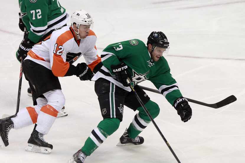 Dallas Stars defenseman Alex Goligoski (33) skates past Philadelphia Flyers left wing...