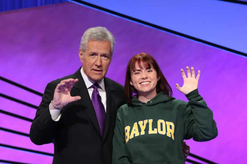 Host Alex Trebek and Baylor student Taylor Roth do the bear claw on the Jeopardy set.