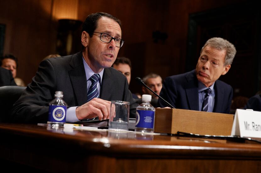 Time Warner Chairman and CEO Jeffrey Bewkes listens at right as AT&T Chairman and CEO...