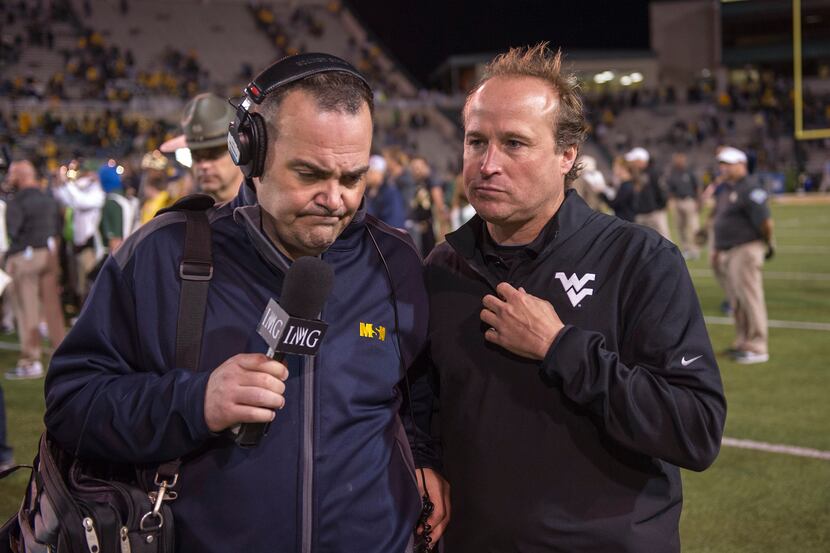 West Virginia Mountaineers head coach Dana Holgorsen comes off the field after a game. The...