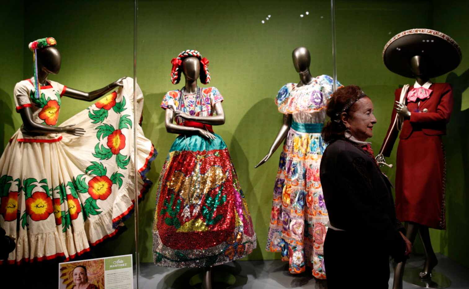 Anita Martinez stands next to her collection traditional ballet folklorico, part of the Eye...