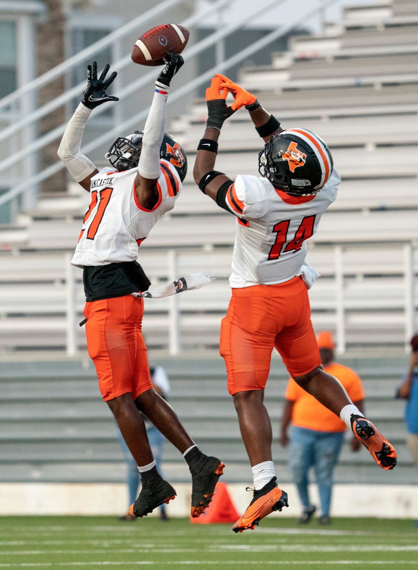 Lancaster defensive backs Toddrick Cobb (21) and Donald Richards (14) go up for an...