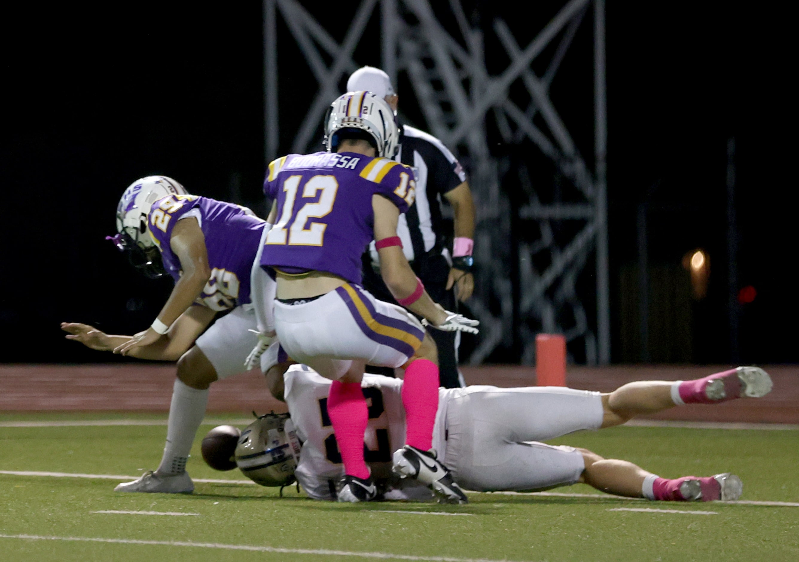 Jesuit linebacker Julien Bird (25), Richardson punter Fernando Gonzalez (29) and defensive...