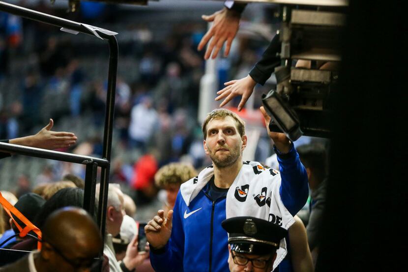 Dallas Mavericks forward Dirk Nowitzki (41) shakes fans hands following an NBA basketball...