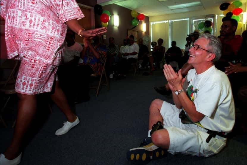 Don Maison, right, claps as AIDS Services of Dallas staff member Melinda Edwards models some...
