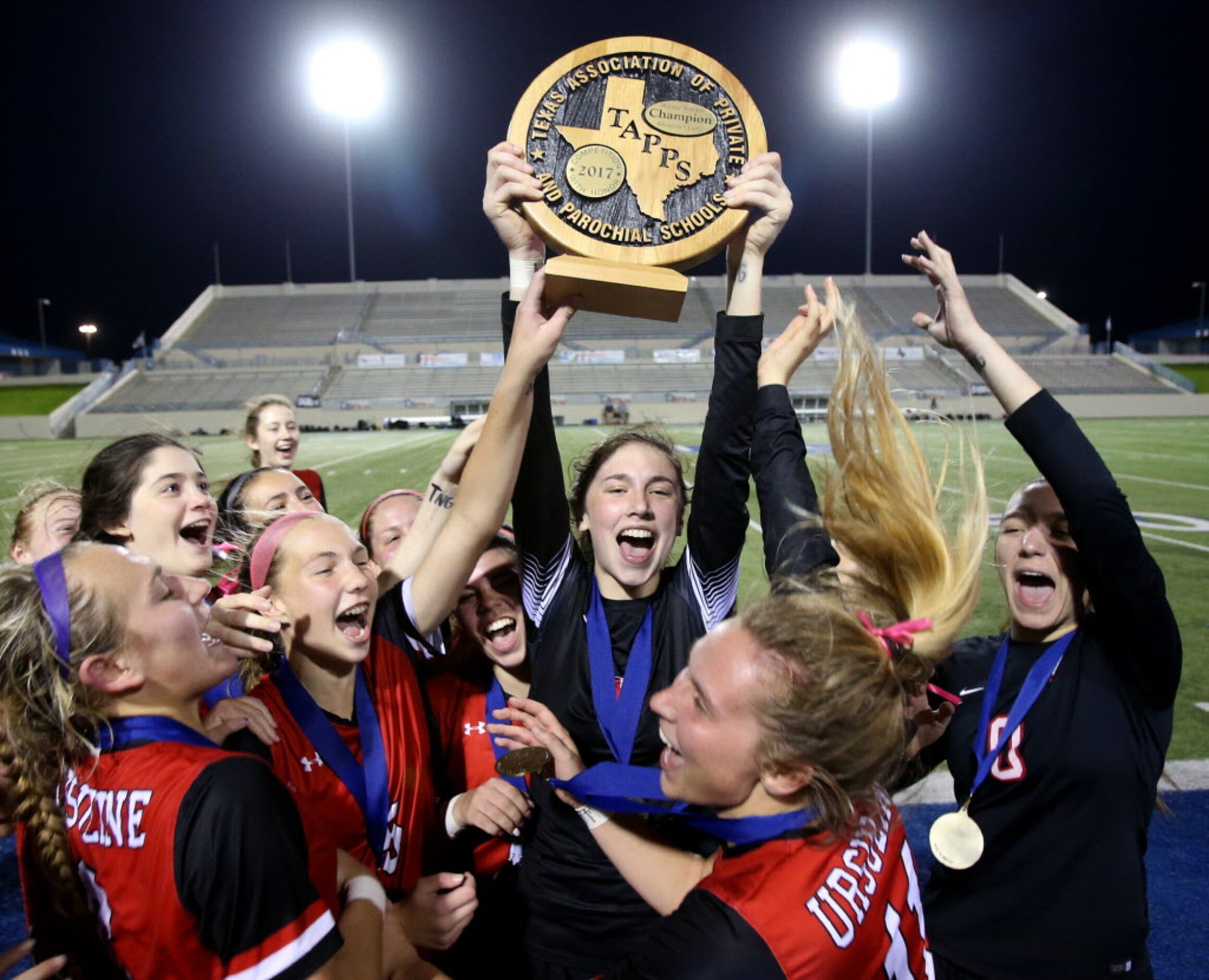 Ursuline Academys goal keeper Leah Archer (1) hoists the Division 1 TAPPS State...